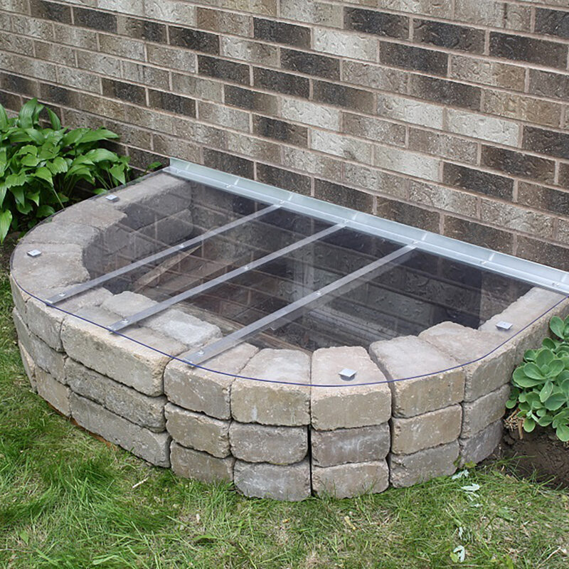 Custom window well cover by shape products installed on a basement window well